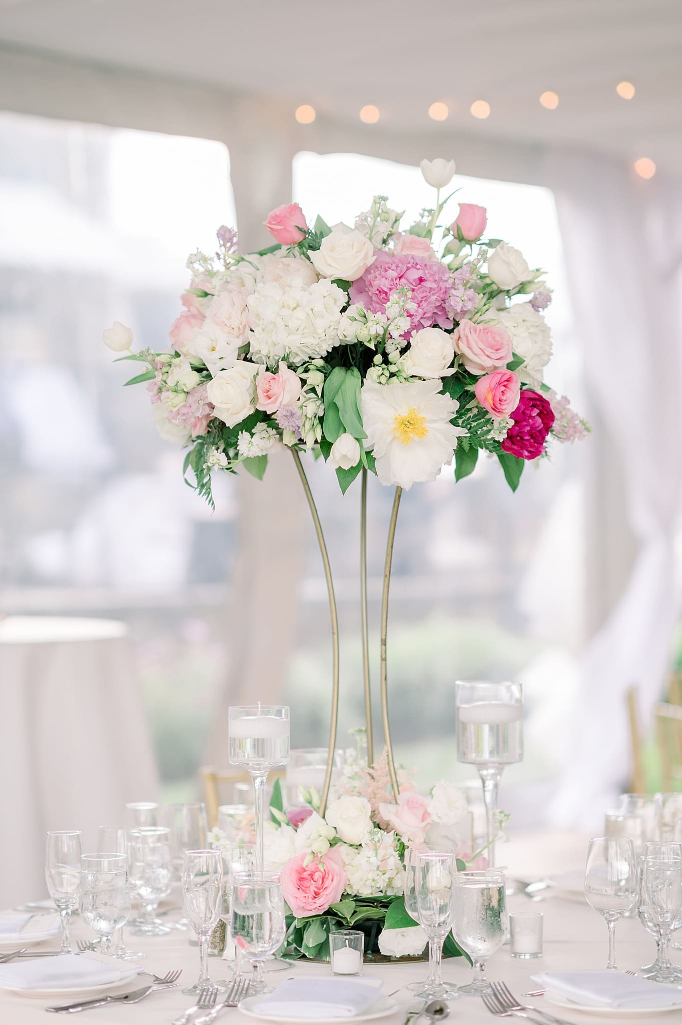 Peonies, white roses, pink roses, hydrangea in a elevated wedding centerpiece at saratoga national